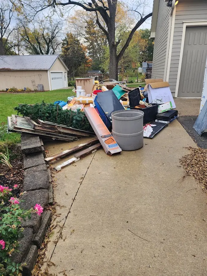 Dumpster being loaded with debris for 12 Yard Dumpster Rental in Crawfordville